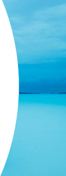 Underground arched corridor with golden lighting reflecting on a still pool of water.