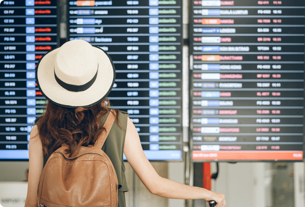 woman looking at flight schedule